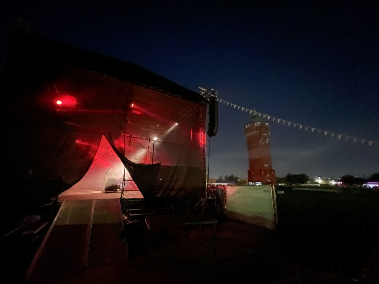 LOW ANGLE VIEW OF ILLUMINATED BUILDING AT NIGHT