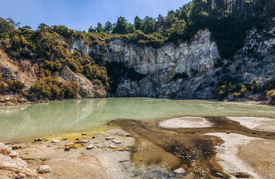 Scenic view of lake by rock formation