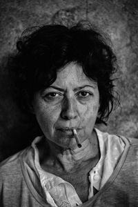 Close-up portrait of mature woman smoking joint
