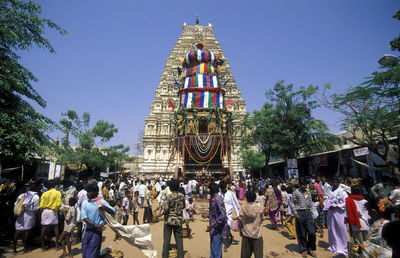 People at hindu temple against sky