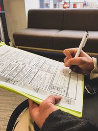 Cropped hands signing on document