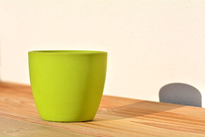 Close-up of drink on table against wall