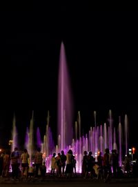 Group of people in front of building at night