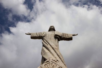 Low angle view of statue against sky