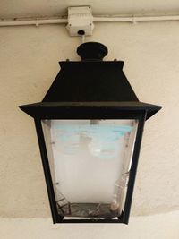 Close-up of electric lamp on wall