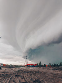 Wind turbines on land against sky