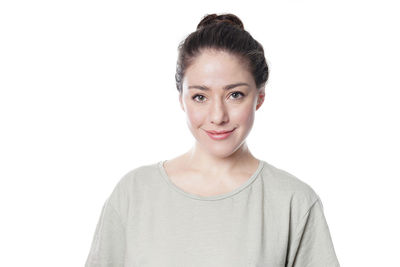 Portrait of a smiling young woman over white background