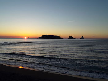 Scenic view of sea against clear sky during sunset