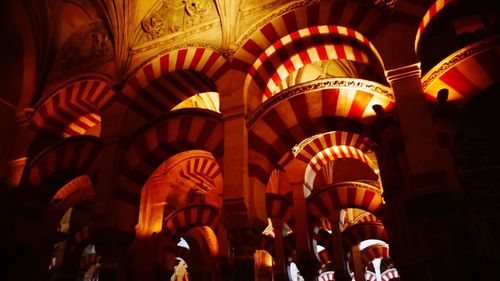 Low angle view of illuminated lanterns hanging in building