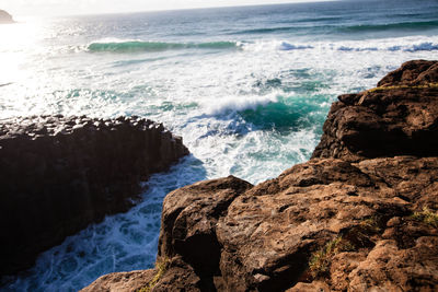 Scenic view of rocks at sea shore