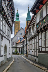 Street amidst buildings against sky in city