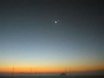 Scenic view of landscape against clear sky at night