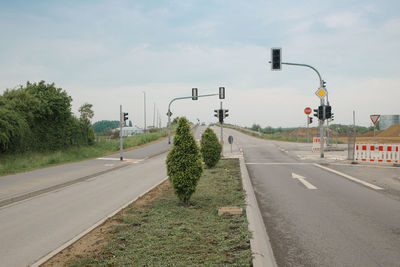 Empty road by street against sky