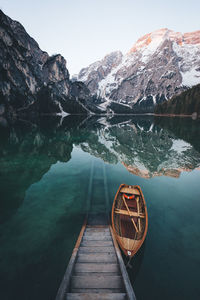 Boat moored on pragser wildsee lake against dolomites