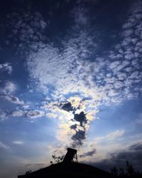 Low angle view of silhouette building against sky