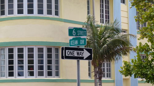 Close-up of sign on tree in city