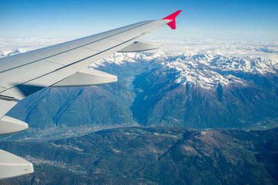 Airplane flying over snowcapped mountains