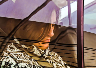 Rear view of woman seen through glass window