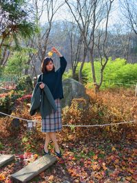 A lady holding a maple leaf