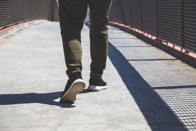 Low section of man walking on footpath