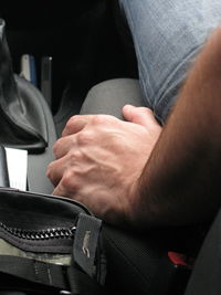Midsection of man sitting in car