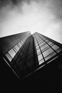 Low angle view of glass building against sky