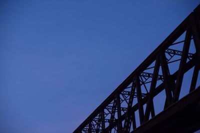 Low angle view of bridge against clear blue sky