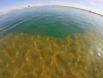 Close-up of yellow water on beach