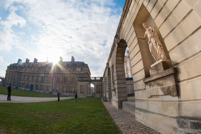 Low angle view of historical building against cloudy sky