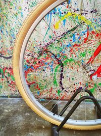 Close-up of bicycle parked against colorful wall