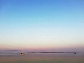 Scenic view of sea against clear sky during sunset