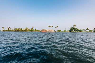 Scenic view of backwaters  against clear sky in kerala