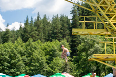 High angle view of men and trees against sky