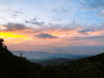 Scenic view of silhouette mountains against sky at sunset