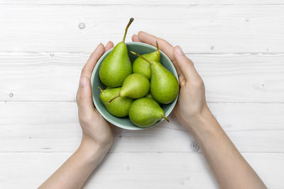 Directly above shot of hand holding fruits