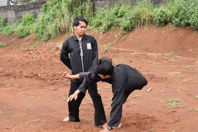 Young men practicing karate outdoors