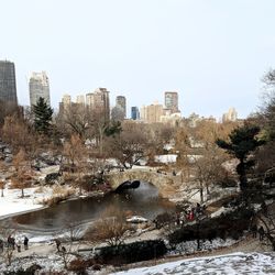 River amidst buildings in city against sky