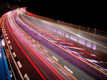 High angle view of light trails on road at night