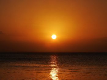 Scenic view of sea against orange sky