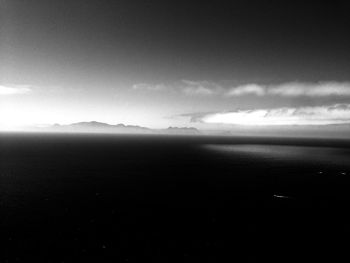 Scenic view of mountains against cloudy sky