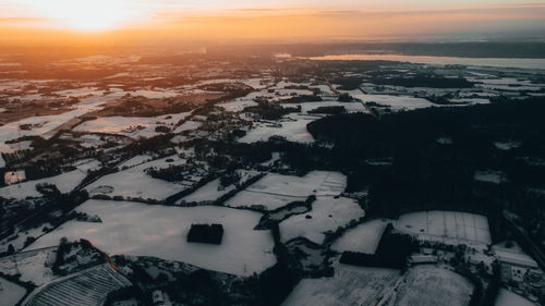 High angle view of buildings in city during sunset