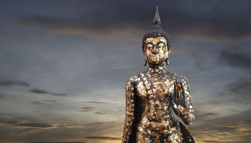 Statue of buddha against sky