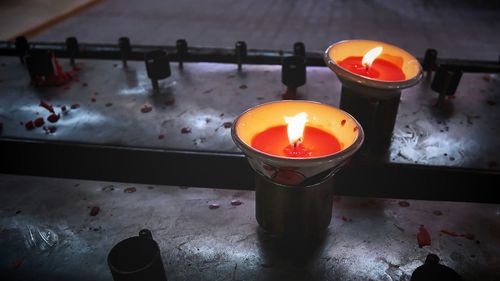 High angle view of lit tea lights