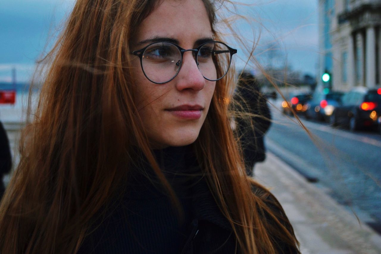 one person, portrait, long hair, hair, glasses, young adult, young women, focus on foreground, real people, headshot, looking at camera, hairstyle, leisure activity, eyeglasses, front view, beauty, lifestyles, brown hair, beautiful woman, outdoors