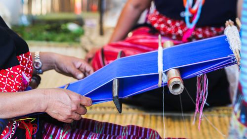 Close-up of woman holding threads