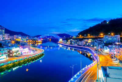 Illuminated city against sky at night