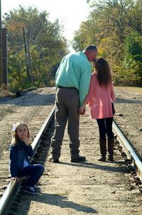 Full length of father and daughter on footpath
