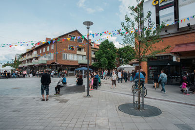 People in city against sky