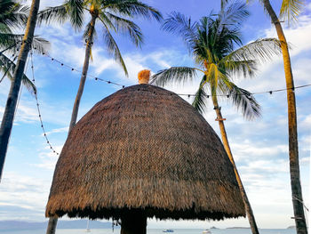 Low angle view of coconut palm trees against sky