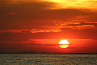 Scenic view of sea against romantic sky at sunset